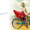 Celeste Giuliano's Pin-ups in 3-D by Schiffer Publishing, Ltd. features a vintage-style pin-up girl in a red skirt and polka-dot headband riding a blue bike with sunflowers. Retro 3-D art captures the “breezy” spirit of this bicycling belle!.