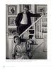 A black-and-white photo of a man in glasses on a staircase above a seated woman, surrounded by art, embodies the creative spirit celebrated in "Perspectives on the Provincetown Art Colony" by Schiffer Publishing, Ltd.