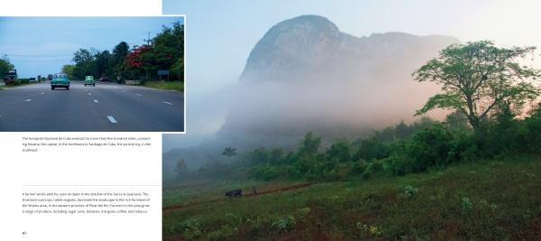 A paved highway with cars leads to rural Cuba and misty green mountains, capturing scenes from Havana in "Cuba's Evolution" by Schiffer Publishing, Ltd.—including grassy plains, scattered trees, and a figure walking cattle.