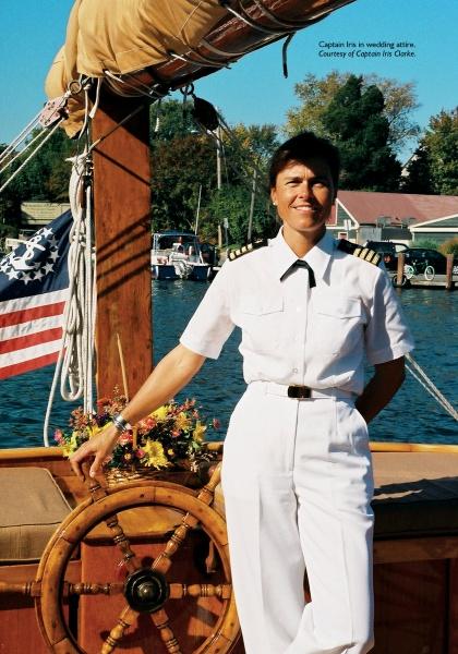 A person in a white captain’s uniform stands by a ship’s wheel with an American flag, evoking Chesapeake Bay’s spirit—just like "Chesapeake Women" from Schiffer Publishing, Ltd. celebrates the region and its storytellers.