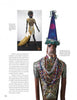 A page from "When the Spirit Speaks" (Schiffer Publishing, Ltd.) displays two African-inspired wood sculptures—one with a blue cone hat and beads, the other in a gold dress with a sack—highlighting ties to self-taught artists and outsider art.