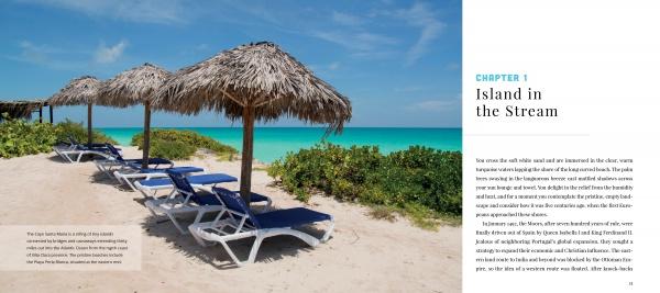 Four blue lounge chairs rest under thatched umbrellas on a sandy beach with lush greenery, facing turquoise waters beneath a bright sky. Text reads: “Cuba's Evolution by Schiffer Publishing, Ltd.” Inspired by contemporary Cuba.