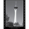 Black-and-white photo of the Stratosphere Tower rises above Las Vegas, evoking haunted tales. From "Ghosts, Gangsters, and Gamblers of Las Vegas" by Schiffer Publishing, Ltd., framed with a dotted border against a clear sky.