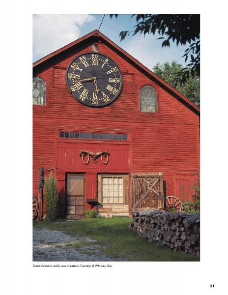 Barn Again" by Schiffer Publishing, Ltd. showcases a spacious red barn ideal for conversion, with a giant clock face above doors and windows, surrounded by wagon wheels, stacked wood, green trees, and blue sky.