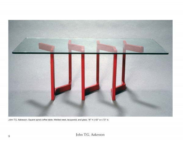 Ironwork Today 3 by Schiffer Publishing, Ltd. features a modern coffee table with a rectangular glass top and red zigzag steel legs resembling metal sculpture, casting dynamic shadows below.
