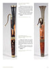 Shown upright in both side and front views, two rare 19th-century wooden bass horns with brass fittings are featured in "Four Centuries of Musical Instruments" by Schiffer Publishing, Ltd., highlighting their unique keys and worn, patched areas.