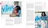 In "The Motherhood of Art" by Schiffer Publishing, Ltd., a woman embraces her child before a vibrant painting; beside them, she stands proudly with her canvas, similar art behind her, surrounded by a text interview on creativity and motherhood.