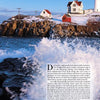 A large wave crashes against rocky cliffs below a white lighthouse and red-roofed buildings, capturing the maritime history featured in "New England Lighthouses" by Schiffer Publishing, Ltd., set on a hill beneath a partly cloudy sky.