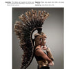 A person wears an elaborate gold and black headpiece resembling a Roman helmet with feather-like extensions, showcasing bold fashion inspired by history—featured in "Emerging Fashion Designers 2" by Schiffer Publishing, Ltd.
