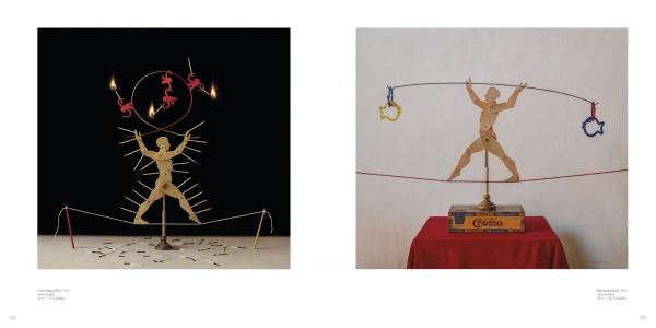 Two photos of wooden acrobat figures recall *Scott Fraser* from Schiffer Publishing, Ltd.: one balances on a tightrope with lit matches and mini acrobats; the other holds rings on a rope above a Chivas Regal box.
