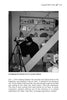 A man in a beanie sits on basement stairs, setting up a video camera among shelves and boxes, as if preparing to document Lehigh Valley ghosts for "Haunted Lehigh Valley" by Schiffer Publishing, Ltd.