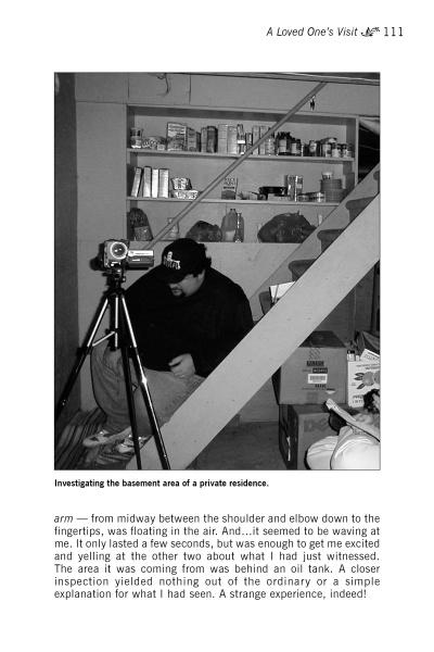 A man in a beanie sits on basement stairs, setting up a video camera among shelves and boxes, as if preparing to document Lehigh Valley ghosts for "Haunted Lehigh Valley" by Schiffer Publishing, Ltd.