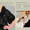 A person models Artisan Felting by Schiffer Publishing, Ltd.—a black, short-sleeved bolero jacket with gold embroidery. Beside them is a workspace flat lay of fabric, thread, scissors, and pattern pieces for crafting.