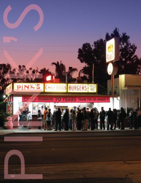 A crowd waits at dusk outside Pink’s, a renowned chili dog and burger stand, featured in Southern California Eats 2 by Schiffer Publishing, Ltd.—an iconic example of the vintage diners that define Los Angeles’s historic food scene.