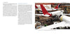 An aircraft assembly hangar features multiple large passenger planes, including an Airbus A300/310 with a red tail by Schiffer Publishing, Ltd., and another with a dark blue and red tail amid scaffolding and construction equipment.