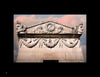 Ghosts in the Cemetery II by Schiffer Publishing, Ltd. features a stone façade with classical carvings—two sculpted faces on each corner, garlands, and a floral medallion—set beneath pink clouds, evoking cemetery photography.