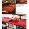 Two photos from "The Countertop Book" by Schiffer Publishing, Ltd. show modern kitchens with bold red countertops—one with a sleek glossy island, the other pairing a red surface and sink with Mondrian-style cabinetry.