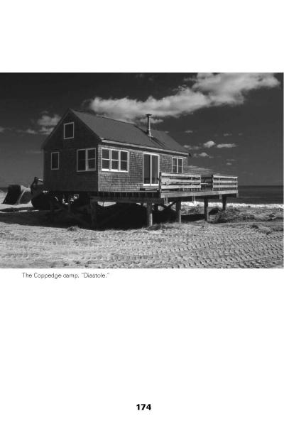 A wooden beach house on stilts stands on sandy ground by the sea under a cloudy sky, illustrating coastal adaptation to rising seas. Caption: The Coppedge camp. Diastole. From Sea Level Rising by Schiffer Publishing, Ltd., p. 174.