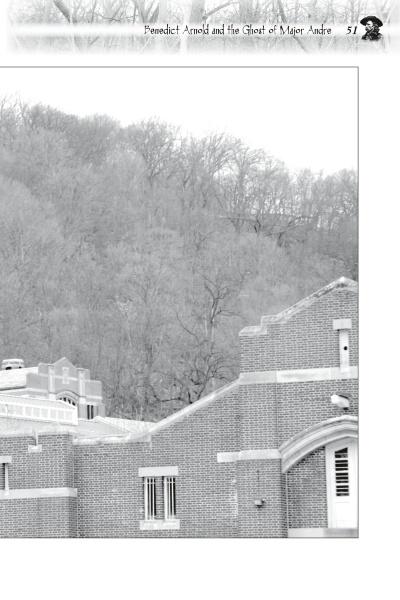 A black-and-white photo of a brick building and leafless trees evokes the chilling tales found in "Fright to the Point: Ghosts of West Point" from Schiffer Publishing, Ltd., exploring eerie legends like those of Benedict Arnold and Major Andre.