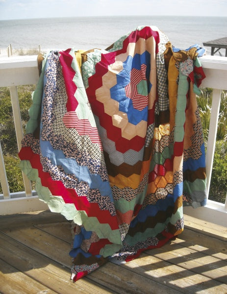 The Recycled Hexie Quilts from Schiffer Publishing, Ltd. add vintage charm to any porch, their graceful hexagon patterns inspiring fresh quilt design ideas in the gentle afternoon light.