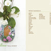 Inspired by gourd painting, "Creating Wall Pockets" by Schiffer Publishing, Ltd. features an egg-shaped pocket painted with pink roses, green leaves, and a bird at a birdhouse. It holds greenery and white flowers; instructions and materials are provided.