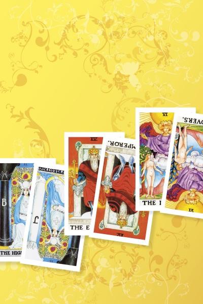 Five vibrant Tarot in Reverse cards from Schiffer Publishing, Ltd. are arranged diagonally on a yellow floral background, showing both upright and reversed cards: The High Priestess, The Emperor, The Hierophant, and The Lovers.