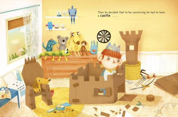 A child wearing a paper crown builds a cardboard castle in a colorful room, inspired by "King of Boredom" from Schiffer Publishing, Ltd., surrounded by stuffed animals and crafts. The wall reads, “Then he decided that to be convincing he had to have a castle...”.