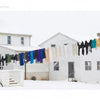 Seasons of Lancaster County by Schiffer Publishing, Ltd. captures the charm of colorful laundry on a clothesline between snowy white houses, a bicycle by a railing, and a white garage in Lancaster County's four seasons.