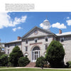 Featured in "Historic Architecture of Pennsylvania" by Schiffer Publishing, Ltd., a classic stone building with a white cupola, arched entrance, and lush landscaping reflects timeless American design beneath a clear blue sky.