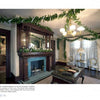 Cape May Perspectives by Schiffer Publishing, Ltd. showcases a formal parlor adorned for the holidays with garlands, ribbons, and candles, highlighting Victorian architecture, an ornate fireplace, chandelier, books, and lace-curtained windows.