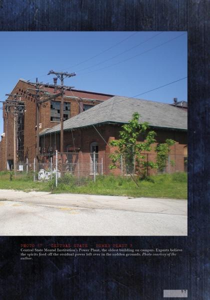 Lost in the Darkness" by Schiffer Publishing, Ltd. captures the eerie mood of a brick industrial building with a sloped roof, chain-link fence, and overgrown grass, while power lines hint at the abandoned atmosphere of haunted asylums.