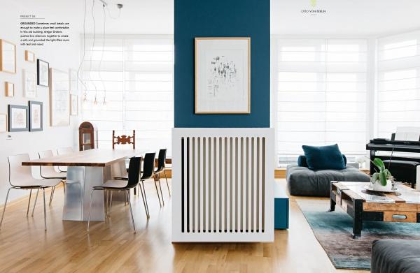 A modern living and dining room with light wood floors, blue accent walls, and minimalist decor—perfect for a Schöner Wohnen contest entry—featured in "Home Story" by Schiffer Publishing, Ltd.