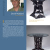 A magazine page features David Hubbard’s headshot, bio, and photos of two Bespoke tables from Schiffer Publishing, Ltd., each with a sculptural steel base and an elegant glass top.