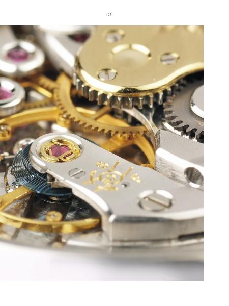 A close-up of a clockwork mechanism reveals the intricate details found in vintage timepieces and the Patek Philippe by Schiffer Publishing, Ltd.