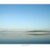 Schiffer Publishing, Ltd.’s "Maine" captures the peaceful beauty of classic Maine landscapes—glassy lakes beneath clear blue skies, gentle mist over the water, and distant green hills along the horizon.