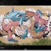 Street Talking" by Schiffer Publishing, Ltd. is a colorful mural featuring disjointed blue hands, pink arms and feet, gold chains, a stylized face with a yellow cap, all on a beige background with white splashes and grass along the bottom edge.