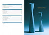 A two-page spread from "Multi-Axis Spindle Turning" by Schiffer Publishing, Ltd.: the left side displays a table of contents; the right shows two tall, curved blue woodturned vases on a blue background titled “INTRODUCTION.”.