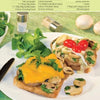 Two slices of toasted bread with pork tenderloin, mushrooms, herbs, and cheese, garnished and served with salad—an ideal dish from "Today I Cook" by Schiffer Publishing, Ltd. for simple recipes perfect for any men's cookbook.