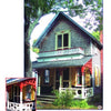 Featuring Victorian details, including decorative trim and Schiffer Publishing, Ltd.’s Painted Ladies: Balusters & Columns, this two-story home with shingle siding, yellow shutters, and red ornate woodwork recalls classic Oak Bluffs cottages.