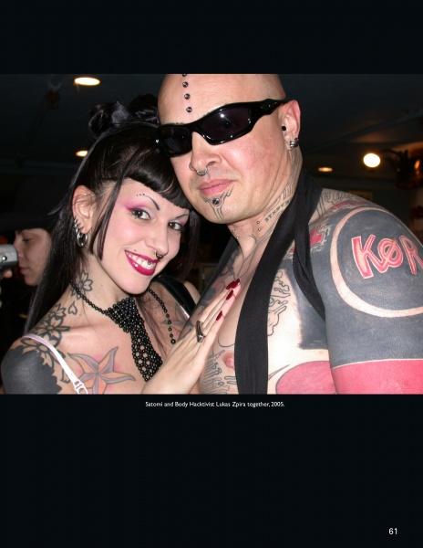A tattooed and pierced couple poses closely for a bold portrait, showcasing the striking body modification style featured in "Ink & Steel" by Schiffer Publishing, Ltd.