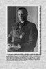 A black and white photo from "Cavalry Divisions of the Waffen-SS" by Schiffer Publishing, Ltd. shows a decorated WWII German officer sitting and looking at the camera, framed by a rough-edged white border.