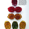 Five intricately carved Bakelite Jewelry pieces from Schiffer Publishing, Ltd. in red, amber, and green are arranged vertically on a white background with a text block in the upper right, showcasing their vintage charm.