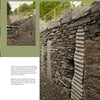 Built with Stone by Schiffer Publishing, Ltd. features stunning stonework, with a stone retaining wall and corrugated metal accents supporting a gravel path and steps, enhanced by greenery and a stylish metal railing above.