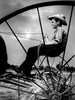 Bodine's Industry" by Schiffer Publishing, Ltd. features a striking black-and-white photo: a boy in a straw hat, holding reins atop old farm equipment, framed by metal spokes against a cloudy sky and open field.