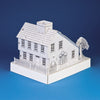 The Saltbox House by Schiffer Publishing is a detailed white paper model featuring a chimney, picket fence, and trees, set against a blue background—ideal as an activity playset for creative minds.