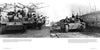 Two black-and-white photos from Schiffer Publishing, Ltd.'s "Sturmgeschütz" show WWII German tank scenes: vehicles lined up indoors with soldiers, and a tank on a dirt road with troops riding atop—a true Legend of Warfare.