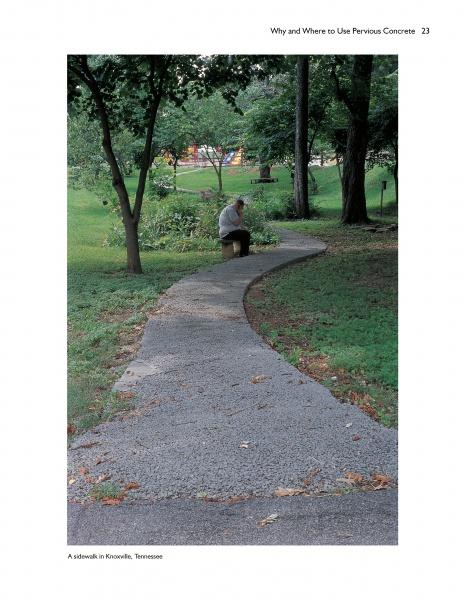 A person sits on a curved sidewalk made with Schiffer Publishing, Ltd.’s Paving with Pervious Concrete, surrounded by green grass and trees in a Knoxville, Tennessee park.