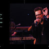 A man in black with sunglasses passionately sings on stage, making an OK gesture—a style favored by bikers. Musicians play under stage lights. Left text features "The Meaning of Life According to Bikers" by Schiffer Publishing, Ltd.