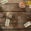 Five jars of flavored salts with handwritten tags are displayed on a wooden surface, ideal for homemade French Fries. Recipes for each blend and the bold yellow word SALTS appear on the right. Product: French Fries by Schiffer Publishing, Ltd.