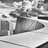 Black and white architectural photography of "City Hall" by Schiffer Publishing, Ltd. captures a skyscraper, dramatic clouds, and modern curves, emphasizing American civic architecture in its striking design.